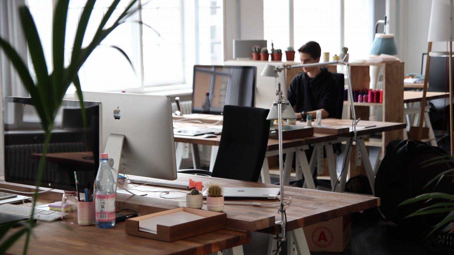 Several desks with a man working at one of them | Surrey web design
