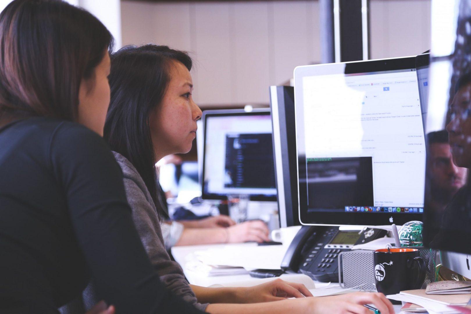 people looking at computer - Surrey web design