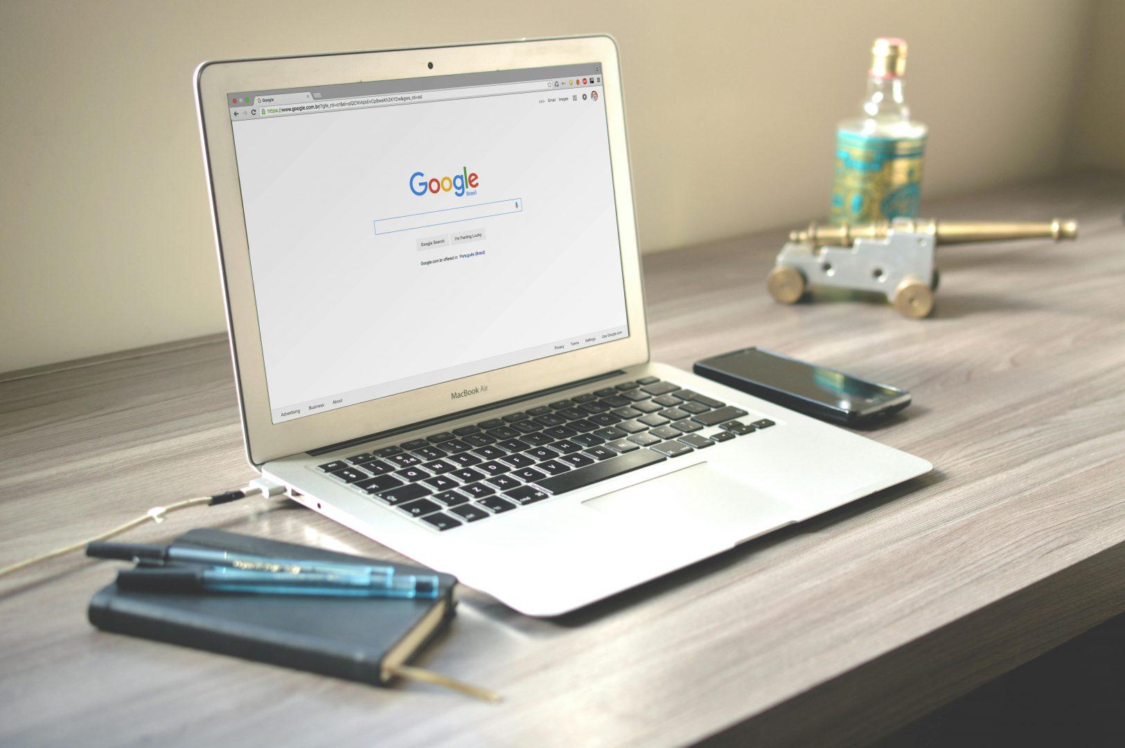 A laptop displaying Google, sitting on a desk | Web designers in Surrey