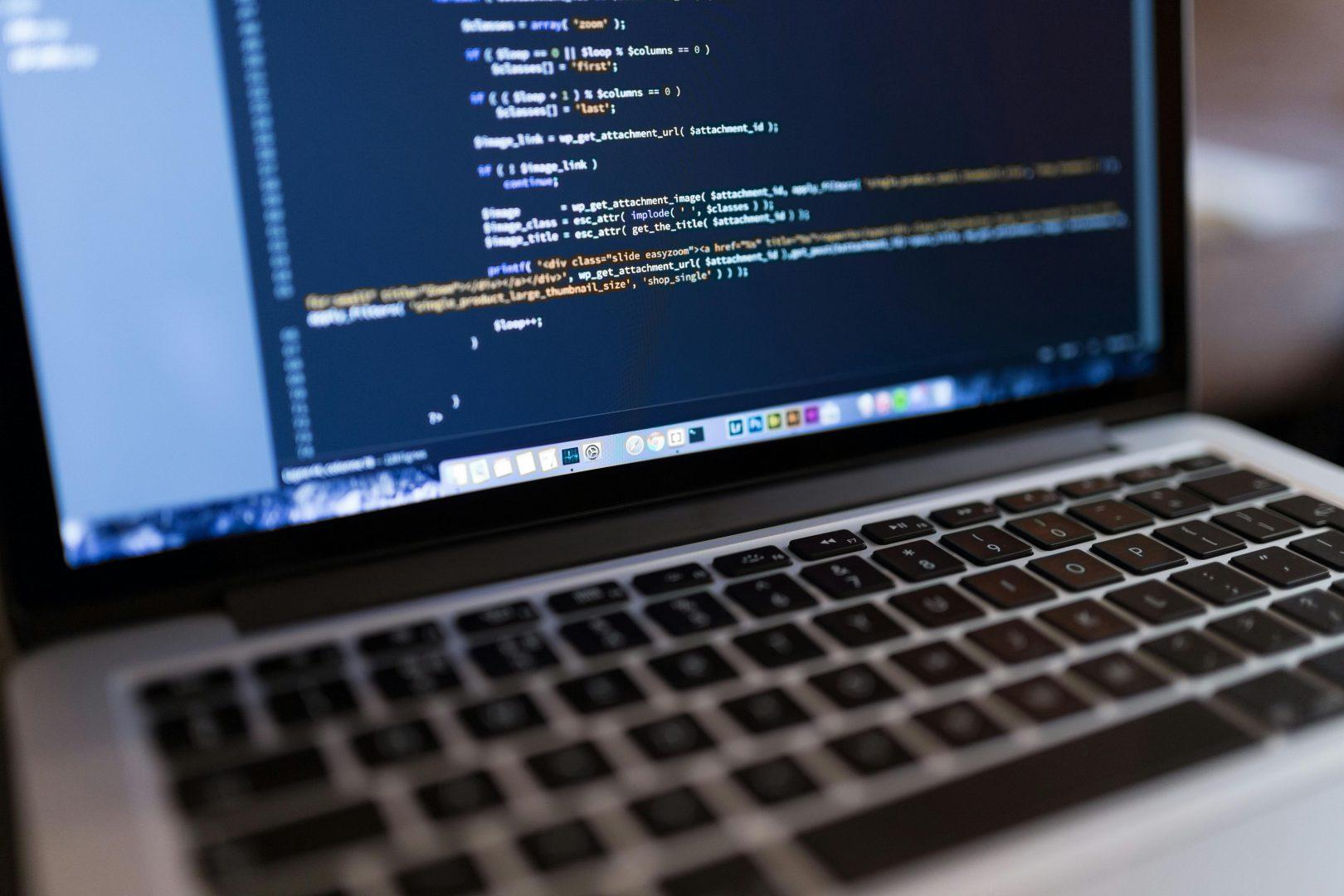 A laptop displaying code at a Surrey website development agency