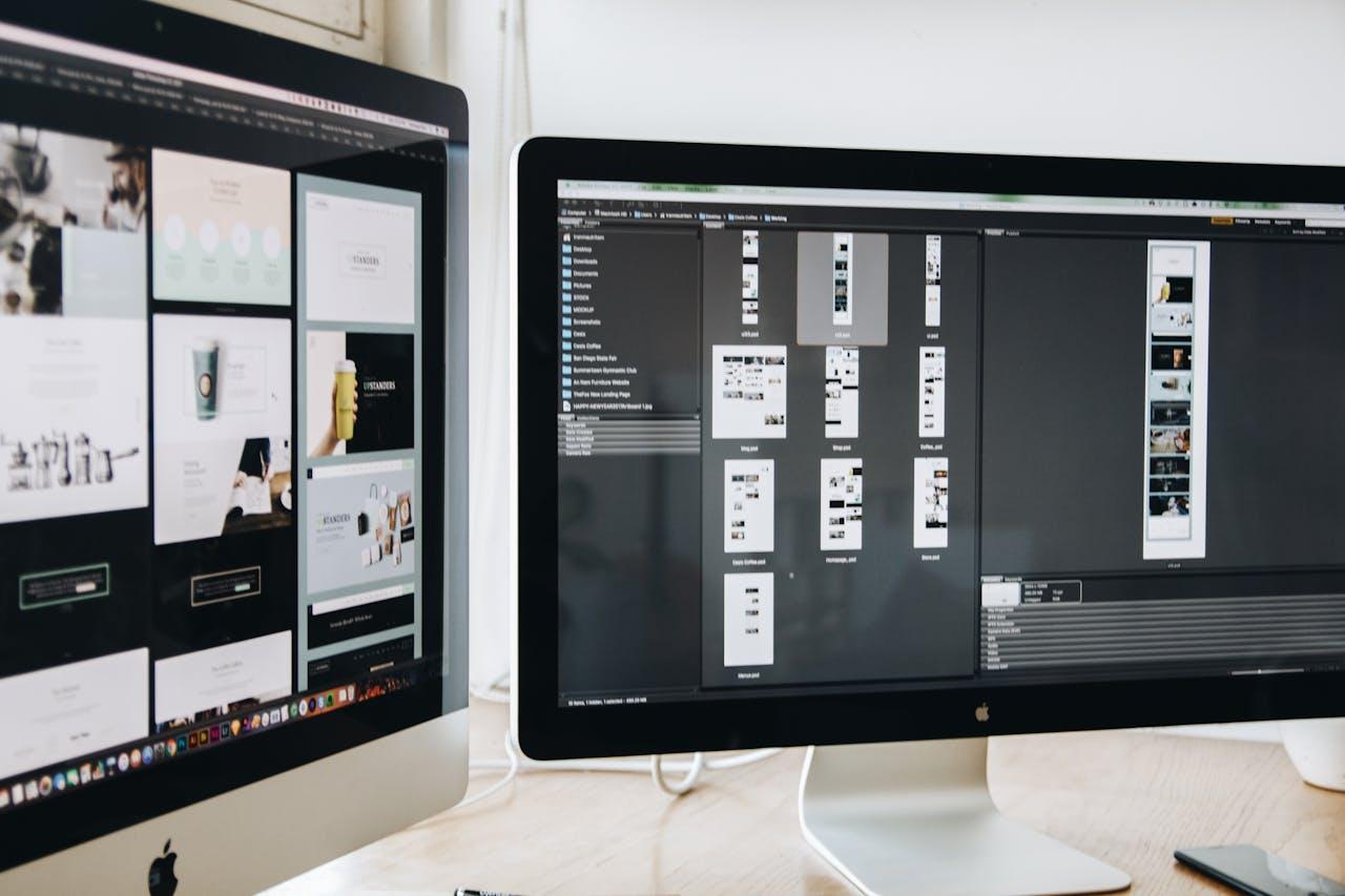 Two computer screens showing designs that might be on the desk of local website designers in Surrey