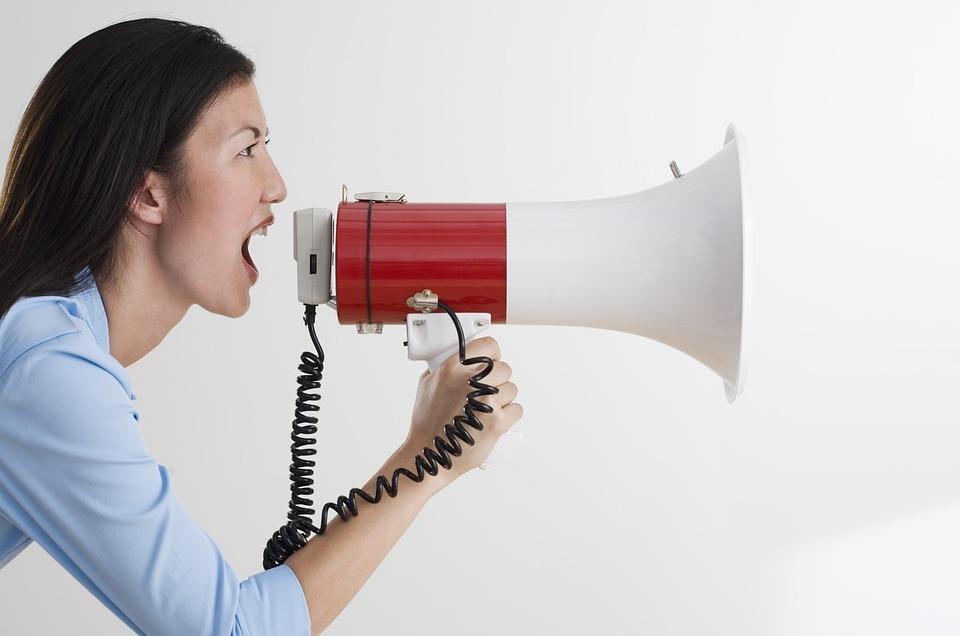 Woman shouting into a megaphone | Social Media Marketing in Surrey | Thunderbolt