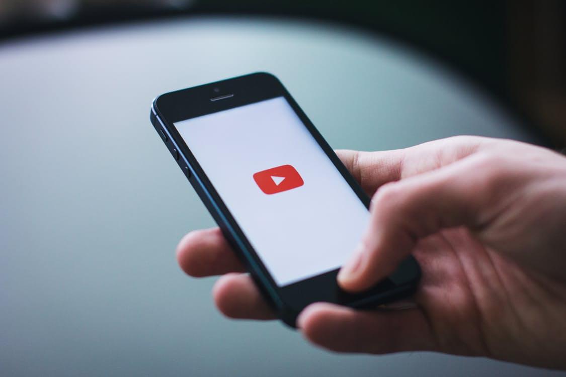 Someone opening the YouTube app on an iPhone Web design surrey | Thunderbolt Digital