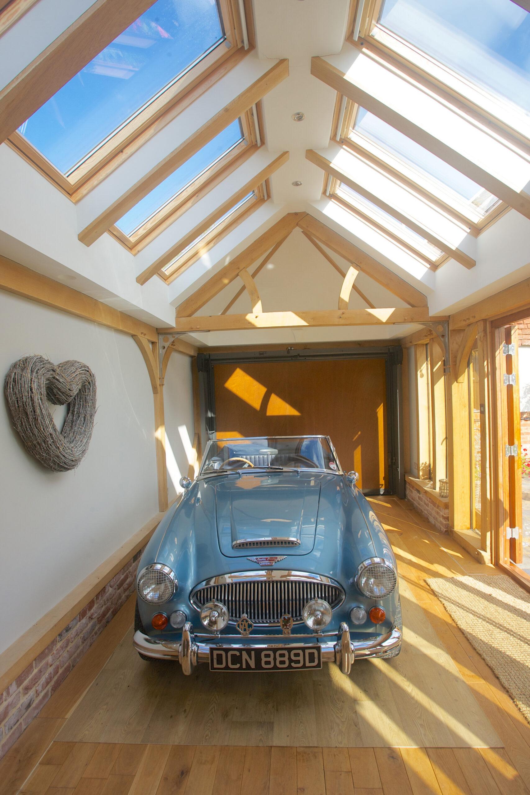 An oak-framed garage housing a classic car