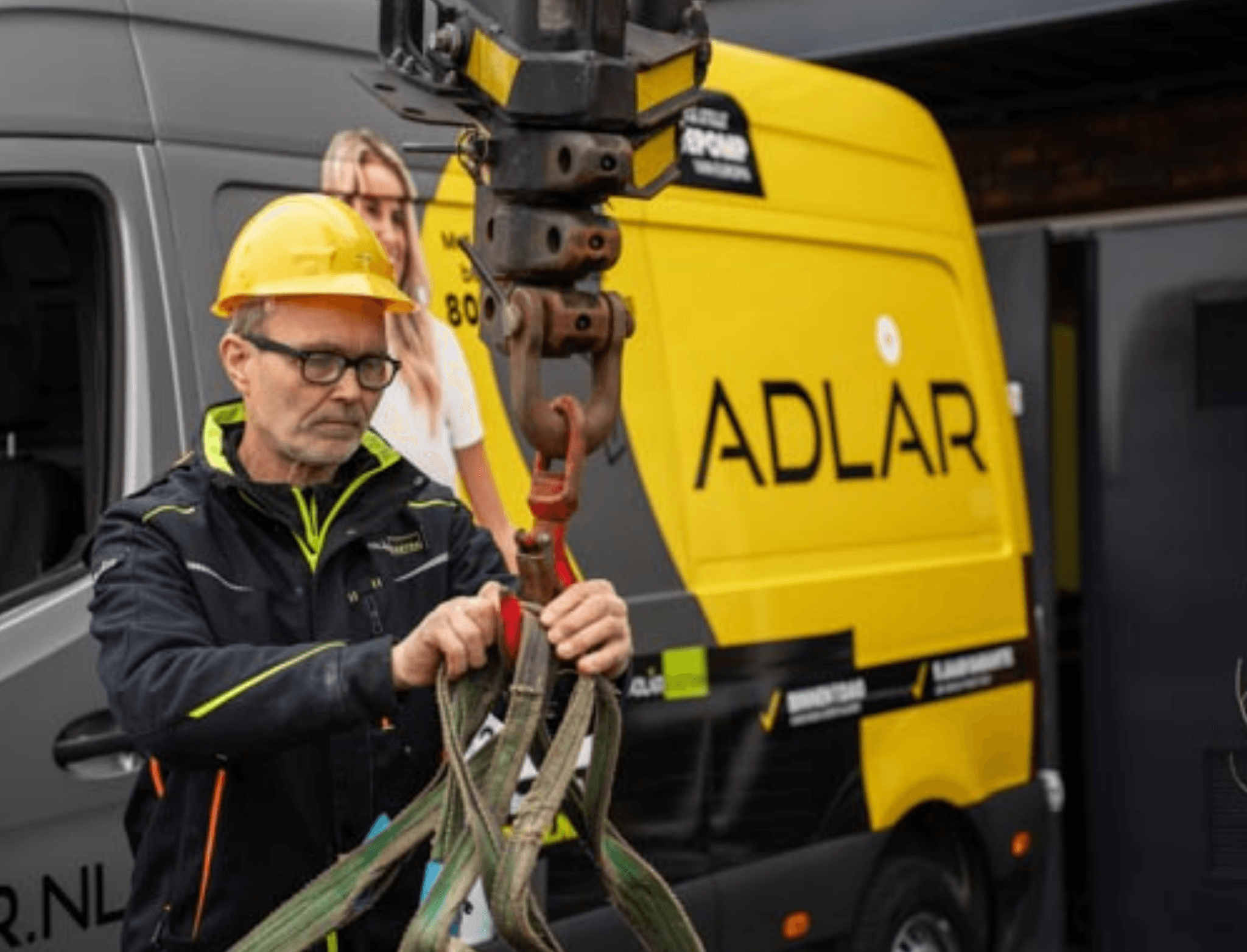 A technician working in front of an Adlår van
